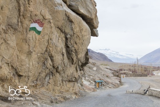 Tajik flag before a small village