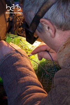 Another electrician fixing a computer motherboard